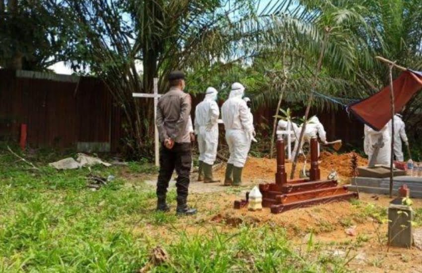 Kapolsek Meliau Iptu Nana Supriatna beserta personel Polsek tampak memberi pengamanan prosesi pemakaman jenazah pasien Covid-19 di Desa Meliau Hulu, Kecamatan Meliau, Sabtu 3 Juli 2021